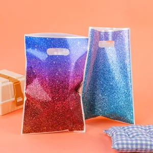 Vibrant gradient glitter gift bags with die-cut handles for party favors and retail packaging.