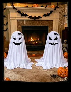 Detailed shot of two white standing ghost decorations with bows for Halloween parties