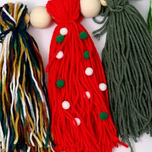 Festive handmade Bohemian Christmas yarn tassel banner with natural wood beads for fireplace