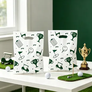 Detailed view of white plastic party favor bags featuring golf themed green prints