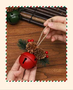Detailed view of a red Christmas bell ornament with pine cones and needles