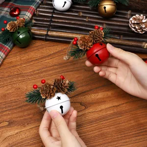 Red and white Christmas bell ornaments with pine cones and spruce for tree decoration