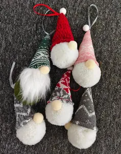 Detailed view of handmade knitted Christmas gnome ornaments with plush pom-poms