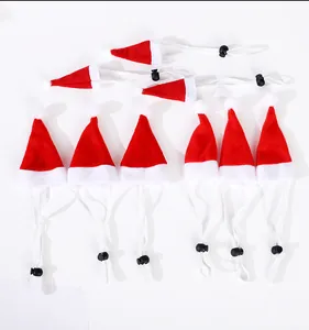 Detailed view of red and white small pet Christmas hats with adjustable elastic straps