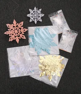 Close-up detail of 3D holographic Christmas snowflake hanging decorations in multiple colors