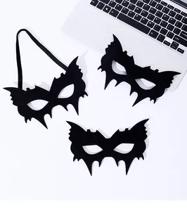 Detailed view of three black bat-shaped party eye masks with elastic bands for Halloween