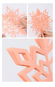 Detailed view of the 3D peach paper snowflake hanging decoration with stitching detail.