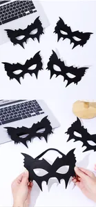 Close-up of black felt bat mask showing soft texture and elastic strap for costume