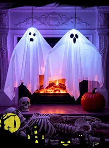 Spooky indoor Halloween scene featuring two glowing LED hanging ghost decorations by fireplace
