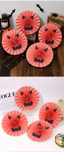 Detailed view of Halloween orange jack-o'-lantern paper fans for festive party decoration