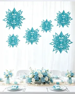Teal blue 3D paper snowflake hanging decorations coordinated with floral table setting.