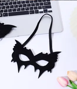 Macro view of the black felt bat-shaped masquerade mask featuring an elastic strap