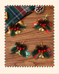 Close-up of four Christmas bell ornaments with festive bows on a rustic wooden table.