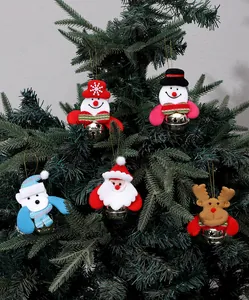 Assorted Christmas ornaments featuring Santa, reindeer, and snowman hanging on a tree