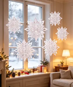 Elegant 3D white paper snowflake hanging decorations in a cozy winter room setting.
