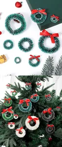 Assorted mini sisal wreaths with red bows shown as festive Christmas tree decorations