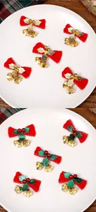 Vista dettagliata di festosi fiocchi di Natale rossi con foglie oro e campanelli