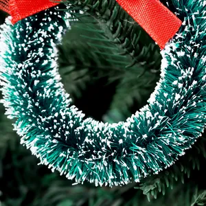 Mini green sisal Christmas wreath with snow tips and red bow for festive hanging decor.