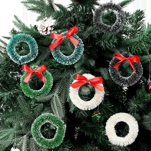 Set of mini colorful sisal Christmas wreaths with red bows hanging on a green pine tree