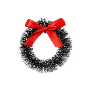 Miniature dark green Christmas sisal wreath featuring a red bow and snowy flocked tips