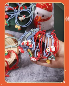 Detailed view of colorful Christmas hair elastics with cute snowman and tree charms