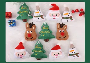 Assorted plush Christmas brooches featuring Santa, snowmen, trees, and reindeer.