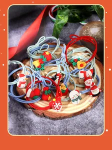 Detailed view of colorful Christmas elastic hair ties with cute Santa and snowman charms