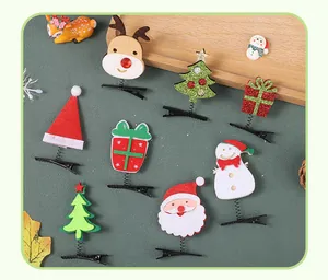 Close-up detail of various Christmas spring hair clips featuring Santa and reindeer motifs