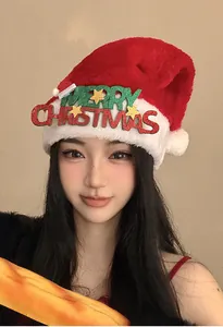 Asian woman wearing a plush red Christmas hat with Merry Christmas text decoration