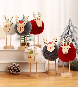 Set of creative Christmas reindeer ornaments with soft wool pom-poms and wooden bases