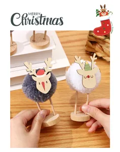Close-up of handmade wool pom-pom reindeer ornaments for Christmas tabletop decor