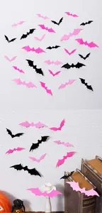 Close-up of 3D pink and black Halloween bat wall stickers on a textured background