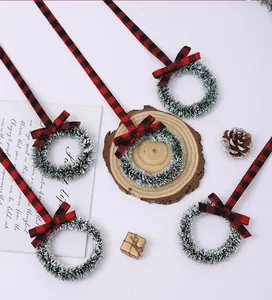 Mini Christmas wreaths with red and black buffalo plaid ribbons and festive bows