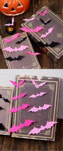 Detail view of 3D pink and black Halloween bat wall stickers on vintage books for decor