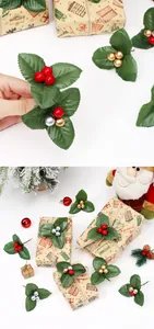 Detail of artificial holly leaves and red berries used for DIY Christmas gift wrapping.