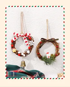 Close-up detail of two mini Christmas rattan wreaths with cute figurines and festive ribbons
