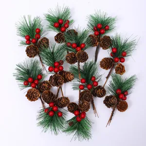 Artificial Christmas pine picks with pine cones and red berries on white background