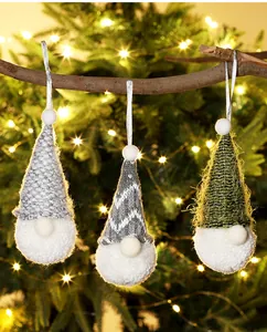 Detailed view of three handcrafted knitted Christmas gnome hanging ornaments with soft texture