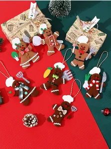 Detailed view of gingerbread man chef plush ornaments for Christmas tree decoration