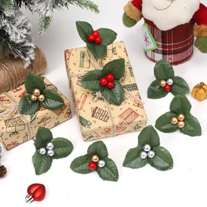 Decorative artificial Christmas holly leaves and colorful berries for festive DIY gift wrapping