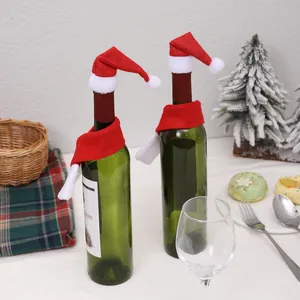 Detail showing mini Santa hats and scarves decorating green wine bottles for Christmas
