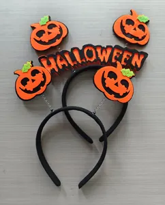 Close-up of Halloween pumpkin headbands with spooky faces and HALLOWEEN lettering text