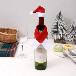 Close-up of red and white Christmas wine bottle scarf and Santa hat decoration on a bottle.