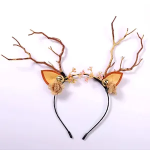 Close-up of a rustic reindeer antler headband with decorative flowers and bells.