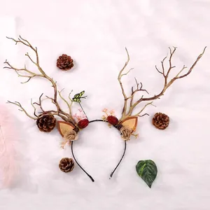 Detailed view of Mori-style glowing reindeer antler headband with pine cones and flowers