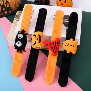 Detailed view of four plush Halloween slap bracelets with pumpkin and ghost motifs.