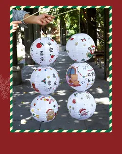 Detail of white Christmas paper lanterns with festive cartoon patterns and Chinese blessings.