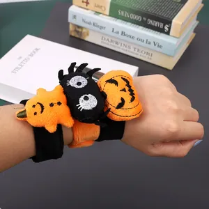 Close-up of Halloween plush snap bracelets featuring pumpkin and spider designs