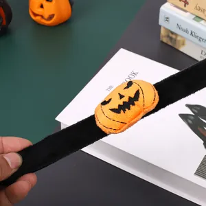 Detail of Halloween plush slap bracelet with orange pumpkin decoration for party accessory