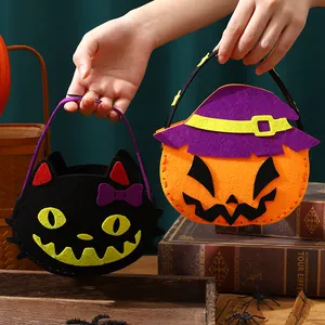 Handmade Halloween felt candy bags featuring pumpkin and black cat characters for children